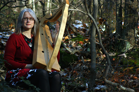 photograph of Cynthia with a harp